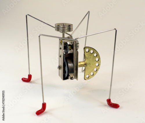 Primitive retro wind-up toy robot spider constructor, isolated on white close-up