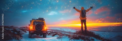 happy male traveler standing next to SUV next sea in nature on winter expedition photo