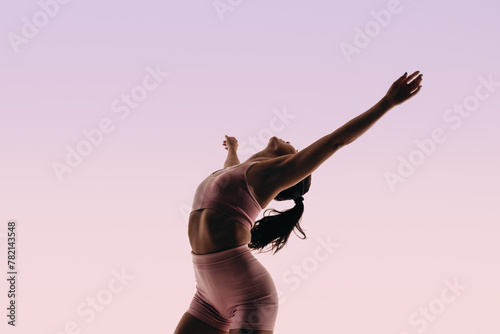 Fit ballerina displaying athletic movement in a studio silhouette © Jacob Lund