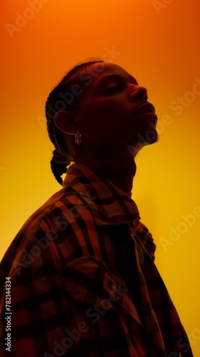 serene profile of stylish man with intense orange glow and shadow play