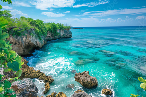 Waves crash against the rocky shoreline. Turquoise sea water crashes on the tropical rocky shore.