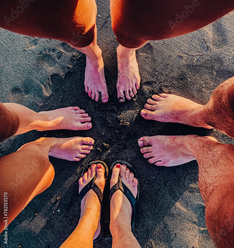 family feet on the beach © Monika