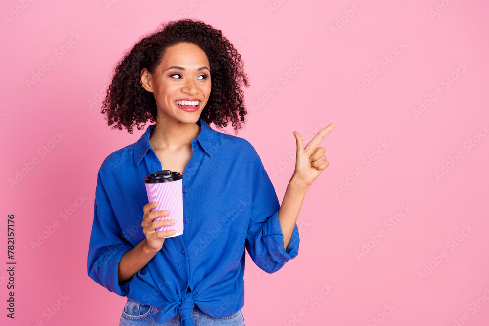 Photo of adorable cheerful pretty woman wear stylish blue clothes hold cup tasty coffee look empty space isolated on pink color background Photo of adorable cheerful pretty woman wear stylish blue clothes hold cup tasty coffee look empty space isolated on pink color background