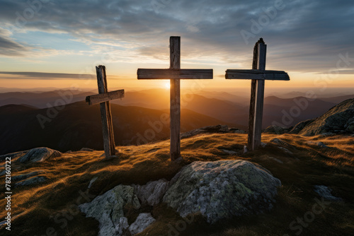 Sunset behind three rustic wooden crosses on mountain
