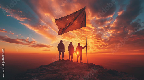 group of people holding a flag with pride against a beautiful sunset sky #782163165