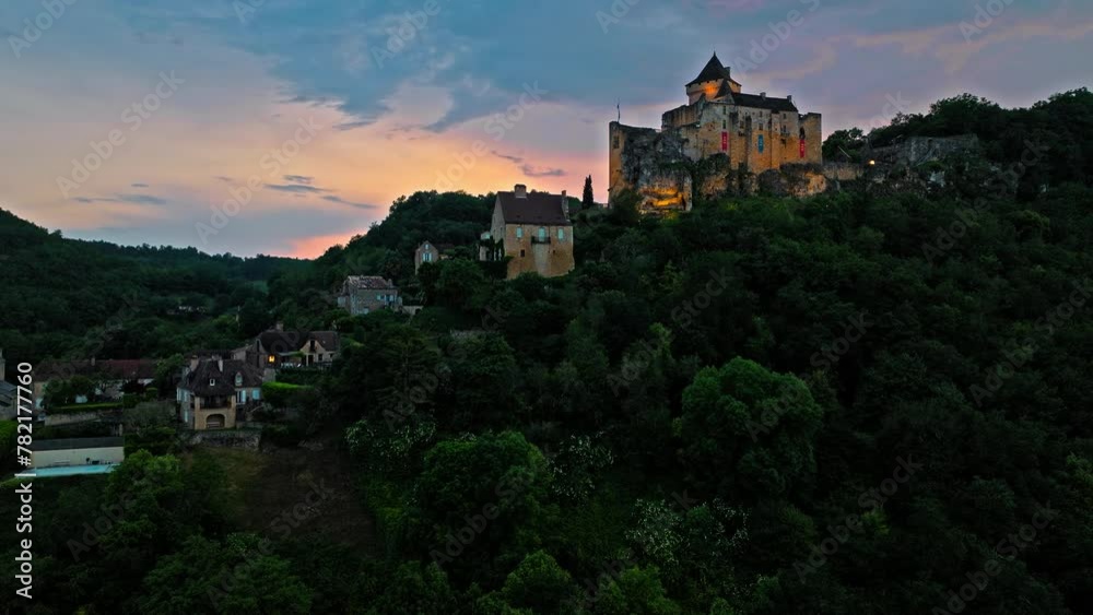 Aerial view of a French medieval fortress housing a large collection of weapons, armour and life-size reconstructions. Cinematic view of Castelnaud-la-Chapelle Castle at golden sunset in France. Aerial view of a French medieval fortress housing a large collection of weapons, armour and life-size reconstructions. Cinematic view of Castelnaud-la-Chapelle Castle at golden sunset in France.
