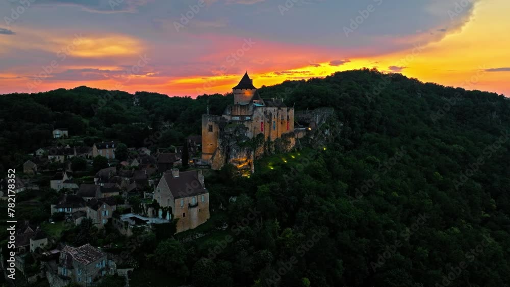 Aerial view of a French medieval fortress housing a large collection of weapons, armour and life-size reconstructions. Cinematic view of Castelnaud-la-Chapelle Castle at golden sunset in France. Aerial view of a French medieval fortress housing a large collection of weapons, armour and life-size reconstructions. Cinematic view of Castelnaud-la-Chapelle Castle at golden sunset in France.