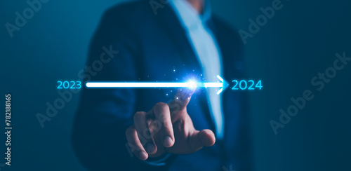 Businessman touch on loading progress from 2023 to 2024,Planning and challenge strategy in new year 2024 Concept. New business startup in 2024. New year 2024 is loading, calendar date, end of the year