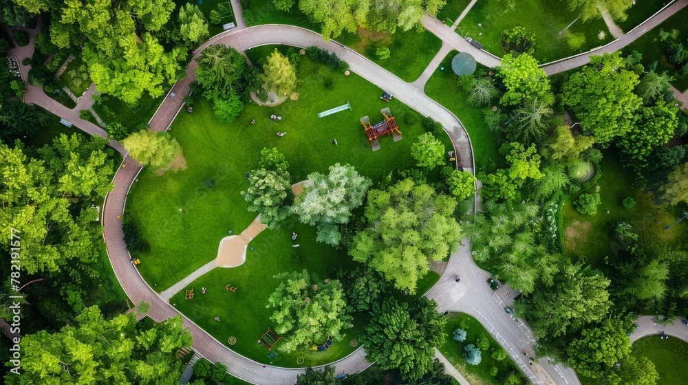 Drones perspective capturing playground area among dense green trees in a park