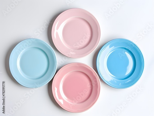 Top view , Pink, Blue, and light Blue pastel coloured plates on white background 
