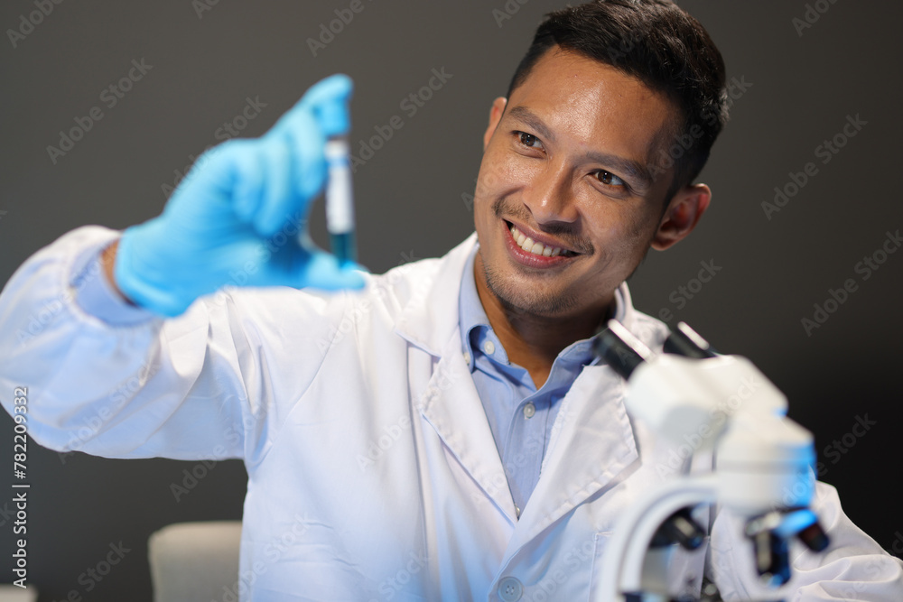 Scientists test the chemical reactions of the colored liquid solution and test biological fluids in test tubes. Scientists test the chemical reactions of the colored liquid solution and test biological fluids in test tubes.