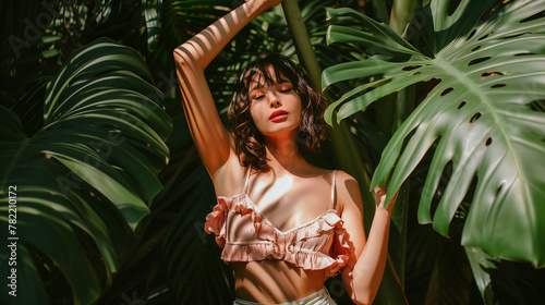 portrait of a woman in the jungle monsterra plants summer tropical