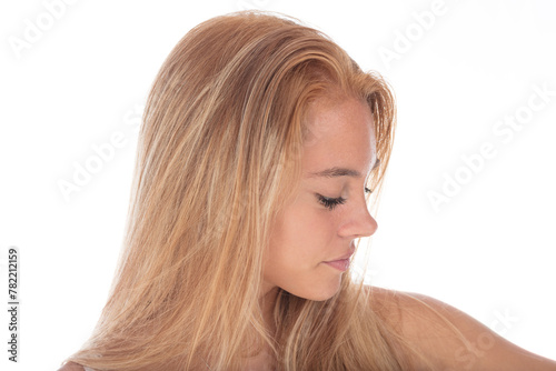 Blonde hair shines, woman contemplates quietly