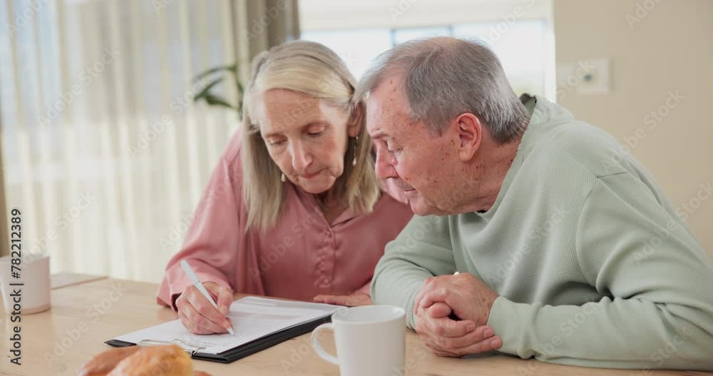 Paperwork, writing and senior couple for finance, budget and planning of expenses or retirement policy. Coffee, agreement and document for signature, mortgage or life insurance for investment in home Paperwork, writing and senior couple for finance, budget and planning of expenses or retirement policy. Coffee, agreement and document for signature, mortgage or life insurance for investment in home