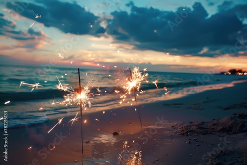 A couple of sparklers shining on the sandy beach. Perfect for summer celebrations