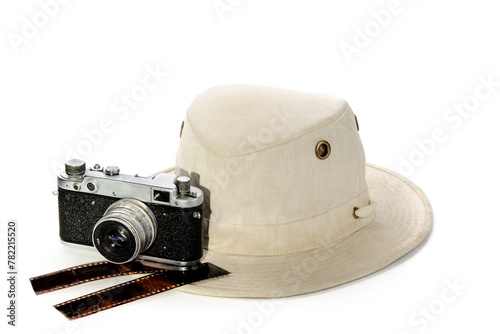 Cotton wide brim men's canvas safari travel hat and a film camera isolated on a white background
