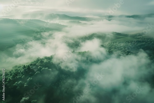 A stunning aerial view of a mountain range covered in fog. Perfect for nature and landscape themes