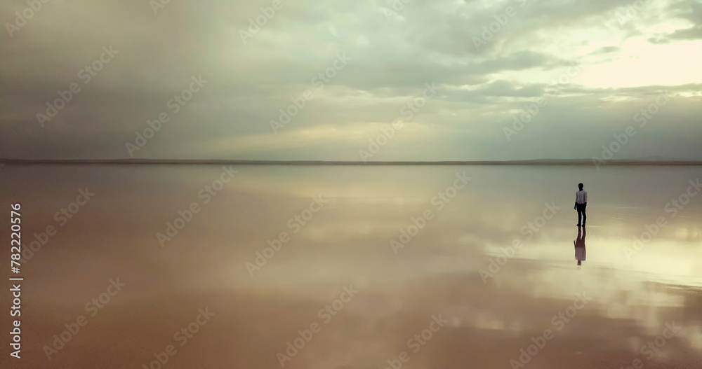 Man running on tropical beach at sunset. aerial view of man running on the beach