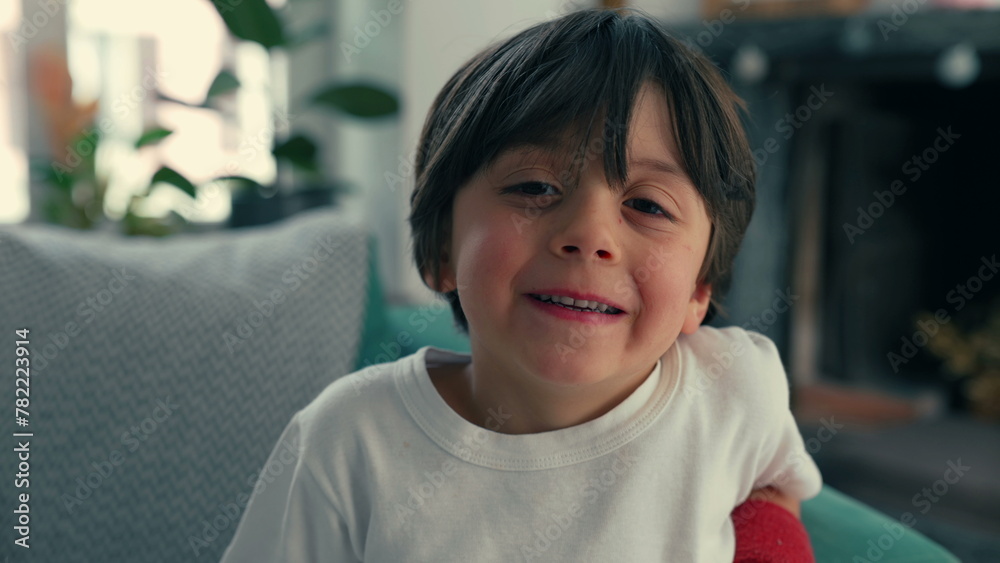 Close-Up Portrait of 5-Year-Old Boy Seated on Home Couch, Indoor Residence, happy emotion Close-Up Portrait of 5-Year-Old Boy Seated on Home Couch, Indoor Residence, happy emotion