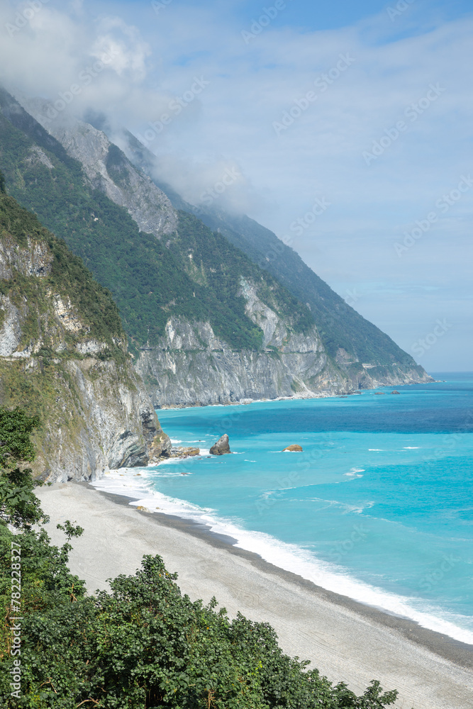 Obraz premium the blue sea with stone beach and mountain in Hualian, Ch'ing-shui Cliff, Taiwan