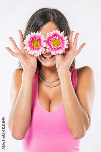 Young woman covering eyes with flowers