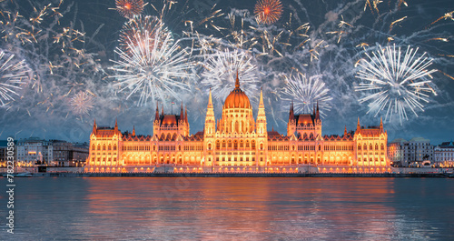Hungarian parliament with fireworks in Budapest at twilight blue hour - Budapest, Hungary