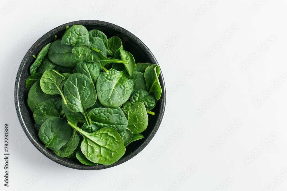 Fresh baby spinach in a bowl on white background Vegetable banner Studio shot Healthy food concept Fresh baby spinach in a bowl on white background Vegetable banner Studio shot Healthy food concept