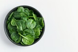 Fresh baby spinach in a bowl on white background Vegetable banner Studio shot Healthy food concept