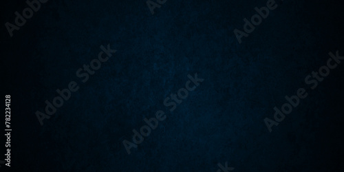Dark Blue background with grunge backdrop texture, watercolor painted mottled blue background, colorful bright ink and watercolor textures on black paper background. photo