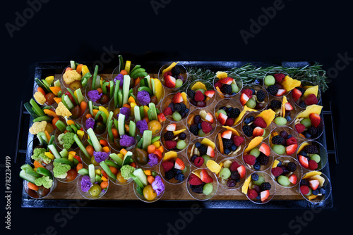 High angle shot of a group of fruit and vegetable cup appetisers.