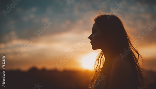 Sunset Silhouette: Long-Haired Figure Bathed in Golden Light 