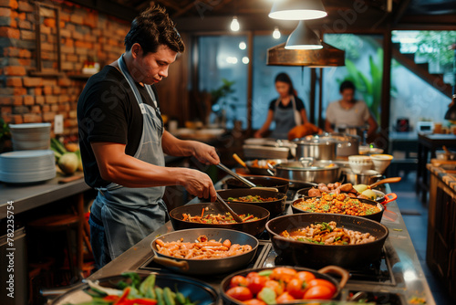 A cultural immersion experience where travelers learn to cook local dishes with expert chefs. A man is preparing dishes in a restaurant kitchen © ivlianna