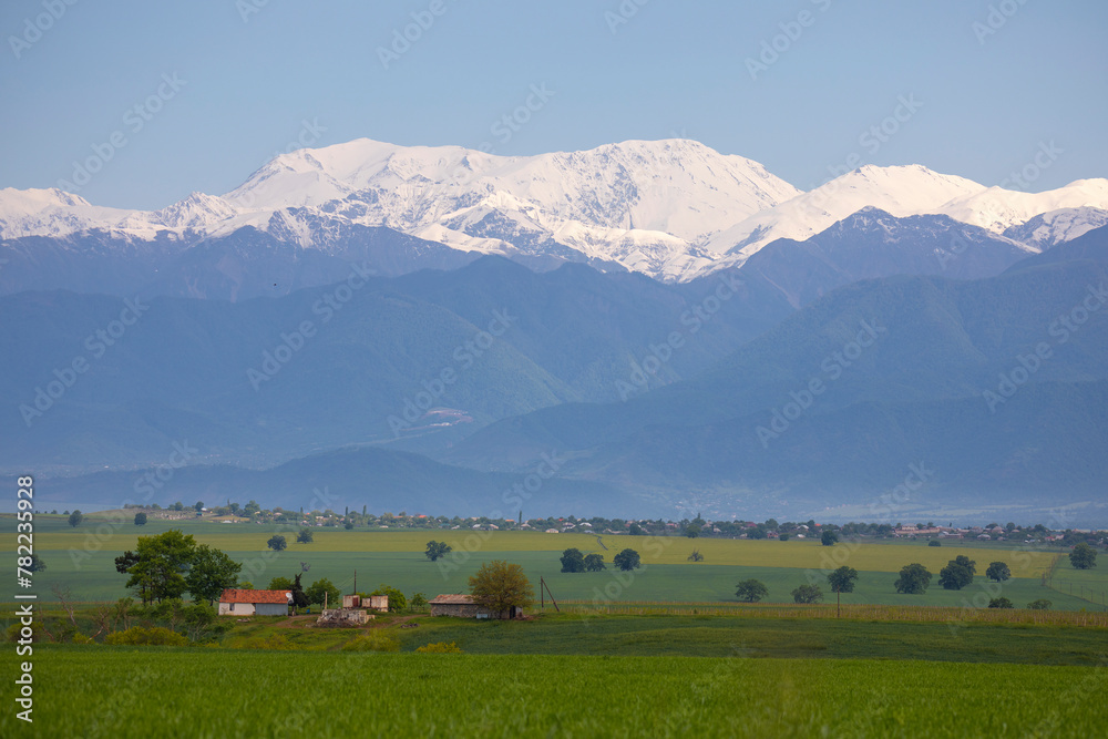Beautiful mountain landscape, green fields in Ismayilli region of Azerbaijan. View of the Caucasus mountain peaks Beautiful mountain landscape, green fields in Ismayilli region of Azerbaijan. View of the Caucasus mountain peaks