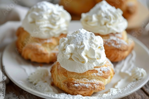 Vanilla and whipped cream filled cream puffs arranged on a plate