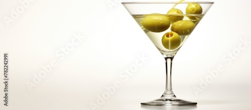 Martini glass featuring olives on a surface