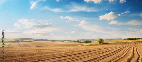 Tractor plowing field under clear blue sky photo
