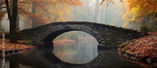 Stone bridge over a creek in a wooded area