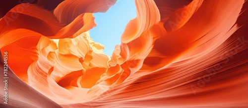 Close-up of towering orange rock against clear blue sky