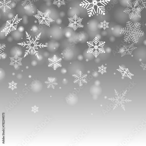 Vector image of the snowfall with the big snowflakes during the blizzard on the gray winter sky background.