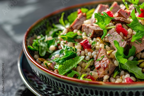 Warm meat and barley salad with greens