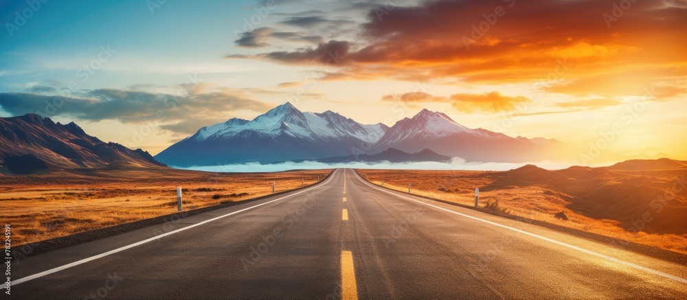 Mountain range and sunset on road