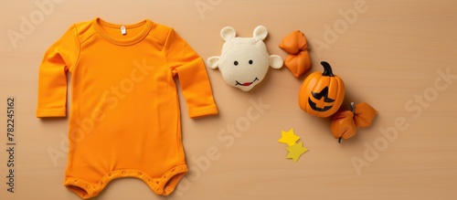 Baby bodysuit, stuffed animal, and pumpkin close-up photo