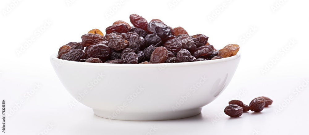 Bowl of Raisins on White Surface Bowl of Raisins on White Surface