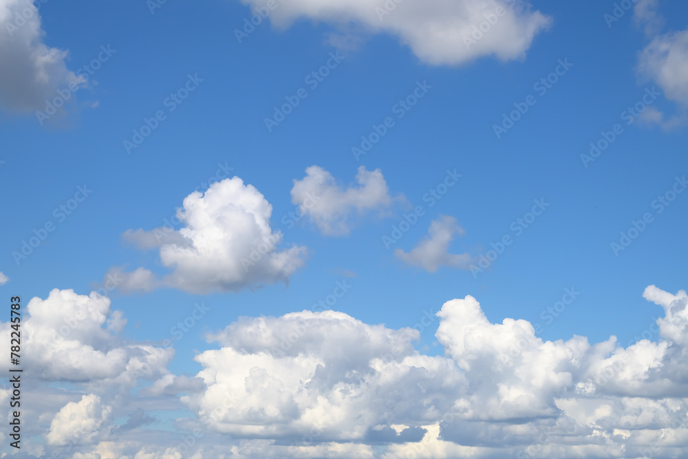 An endless blue sky with white clouds floating over the horizon. Panoramic view of the cloudy sky. Cumulus white clouds. Cloudy weather. An endless blue sky with white clouds floating over the horizon. Panoramic view of the cloudy sky. Cumulus white clouds. Cloudy weather.