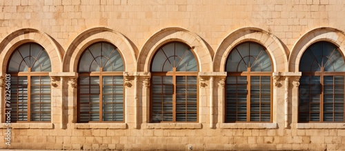 Old building with distinctive arched windows and bench