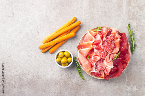 Charcuterie board. Antipasti appetizers of meat platter with salami, prosciutto crudo or jamon and olives. 