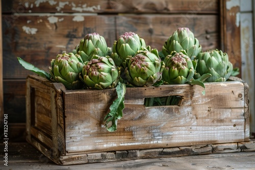 Wooden box filled with artichokes photo