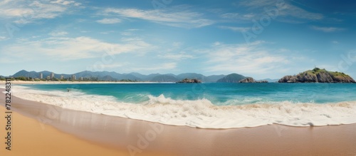 Scenic Beach with Mountain Backdrop and Waves