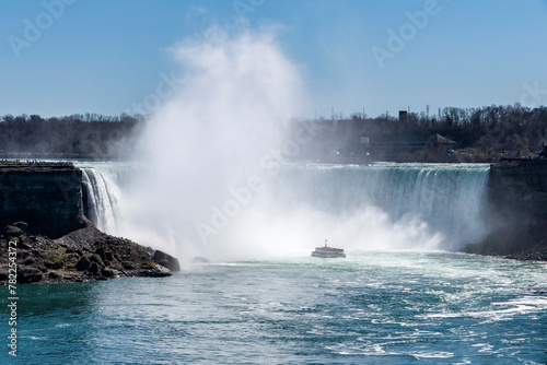 A Tourist Boat Full of People Approaching Niagara Falls Canada on a Sunny Spring Day