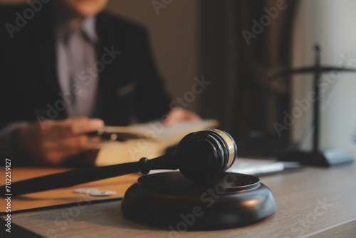 Business and lawyers discussing contract papers with brass scale on desk in office. Law, legal services, advice, justice and law concept picture with film grain effect